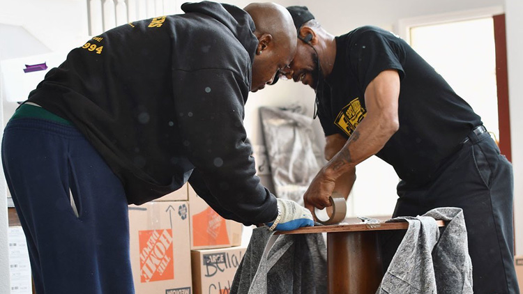 movers packing up furniture